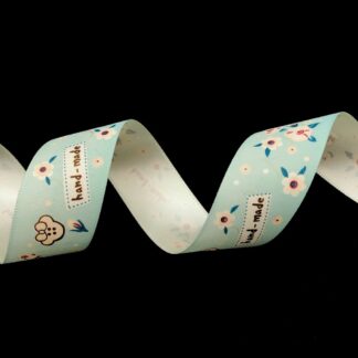 Light green ribbon with words hand-made in brown and flowers by metre - width 26 mm