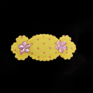 Pink rhinestone flowers on polka dots yellow candy-shaped fabric decoration - size 22 x 50 mm