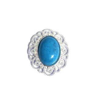 Silvery white oval metal ornament with blue cabochon - size 36 x 42 mm