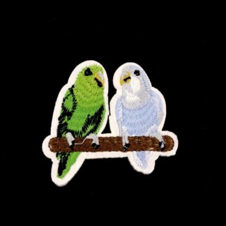 Green and blue birds on brown bar iron-on garment sticker by piece - size 62 x 70 mm