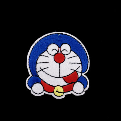 Red blue and yellow cat on white iron-on garment sticker by piece - size 55 x 60 mm