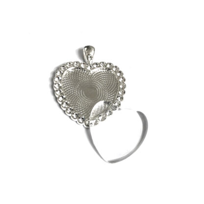 Silvery metal heart bezel pendant with rhinestone boundary and glass cabochon - size 32 x 41 mm