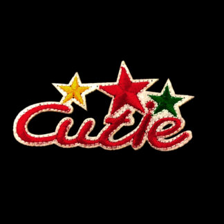 Red word Cutie with yellow and green stars on white iron-on garment sticker by piece - size 42 x 80 mm