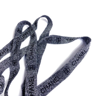 Glittery grey binding with black logo and word CHANEL by metre - width 20 mm