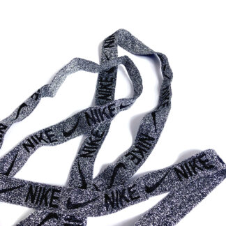 Glittery dark silvery binding with word NIKE and logo in black by metre - width 20 mm
