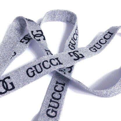 Glittery silvery grey band with black logo and word GUCCI by metre - width 20 mm