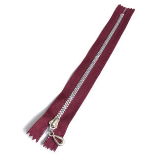 Red brown zipper with iridescent plastic teeth and silvery metal slider - length 20 cm