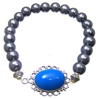 Oval blue cabochon on silvery metal base bluish dark grey beads bracelet - diametre 8 mm